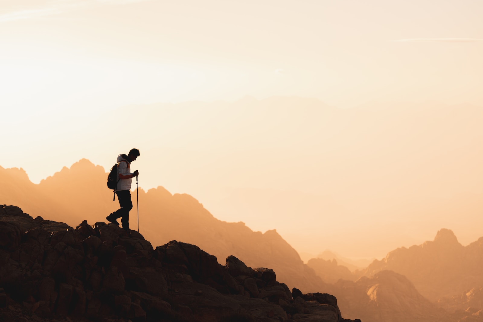 Photo by NEOM a couple of people standing on top of a mountain